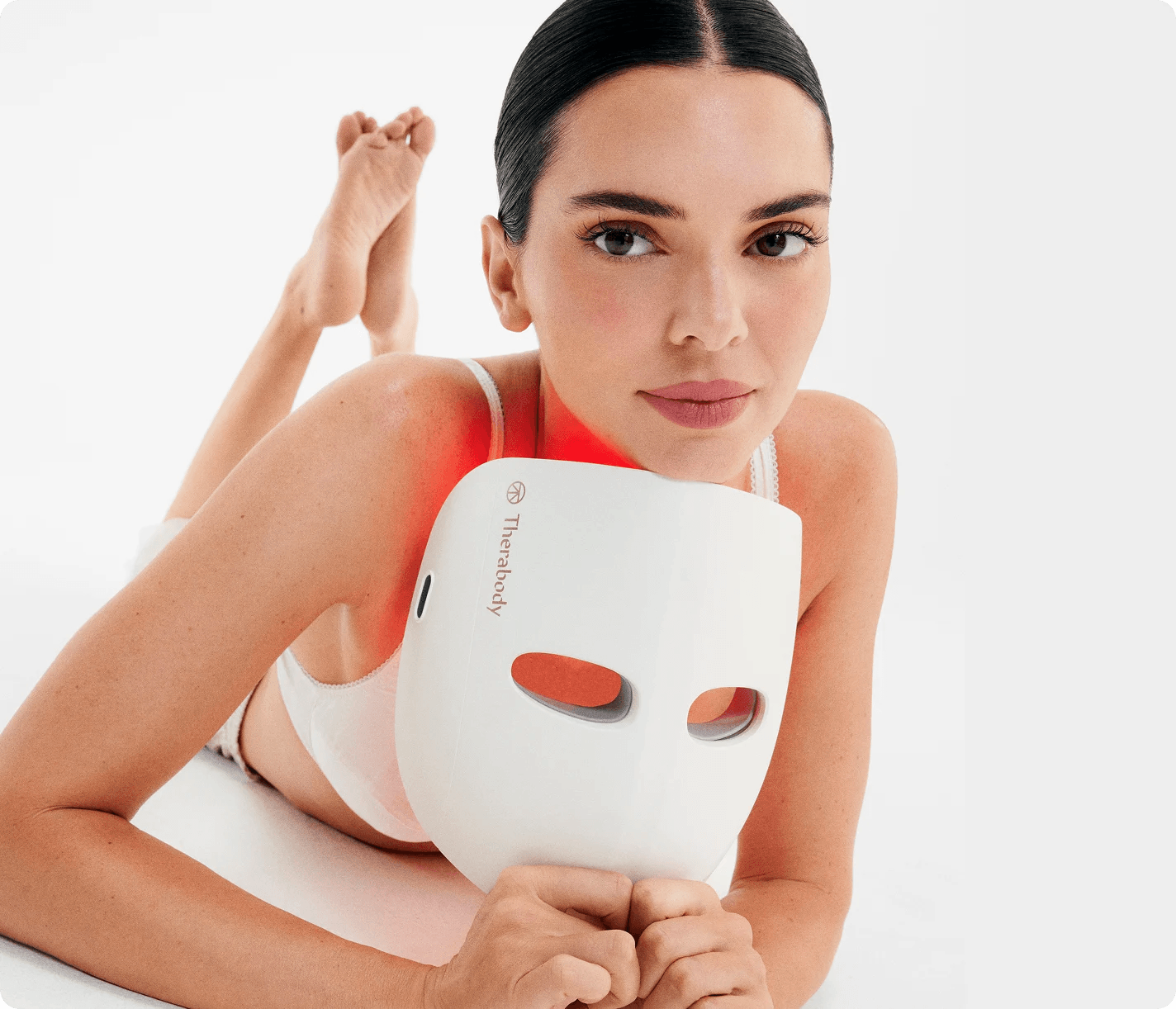 Kendall Jenner holding a LED Mask from Therabody